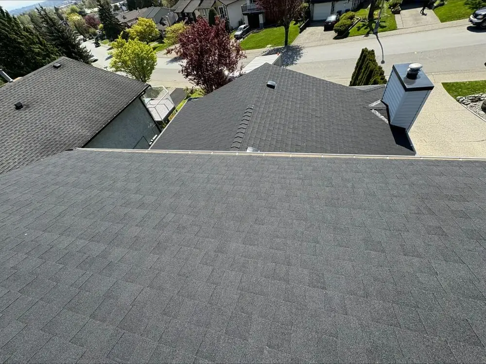 Close-up of a new seamless gutter and downspout installation in Coquitlam, BC