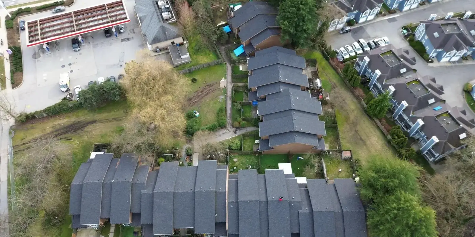 Crew torch-applying a modified bitumen membrane on a flat roof in Richmond, BC