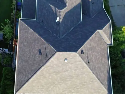 Full Roof Replacement — Finished hip roof from a side angle, tight fascia lines.