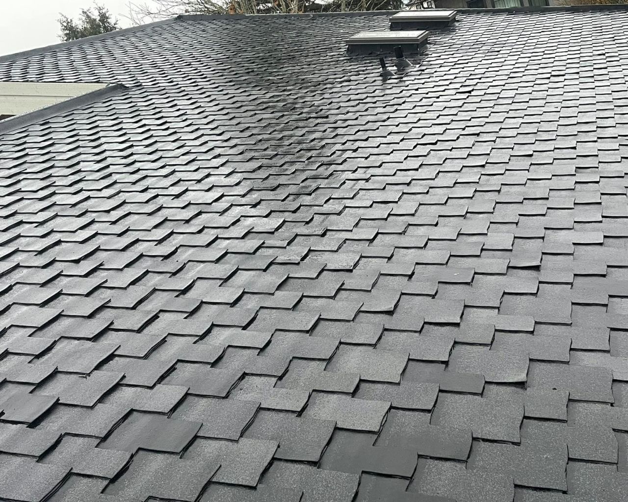 Roof inspector examining shingles and flashing in Surrey, BC